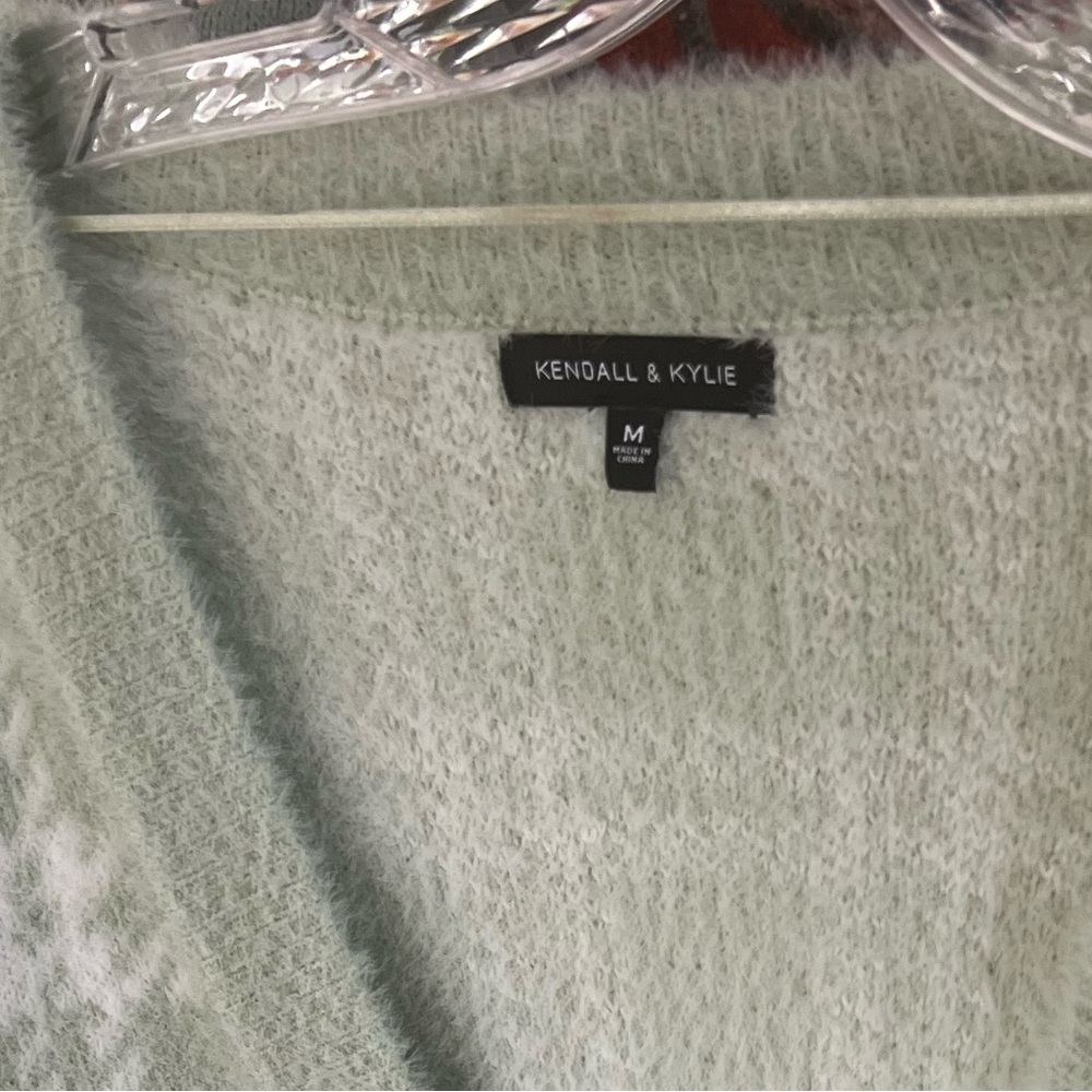 Cute cardigan! You can wear this with just a tank top under breath! It’s fuzzy